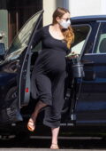 Emma Stone shows her baby bump as she leaves a medical building before picking up a framed art in Studio City, California