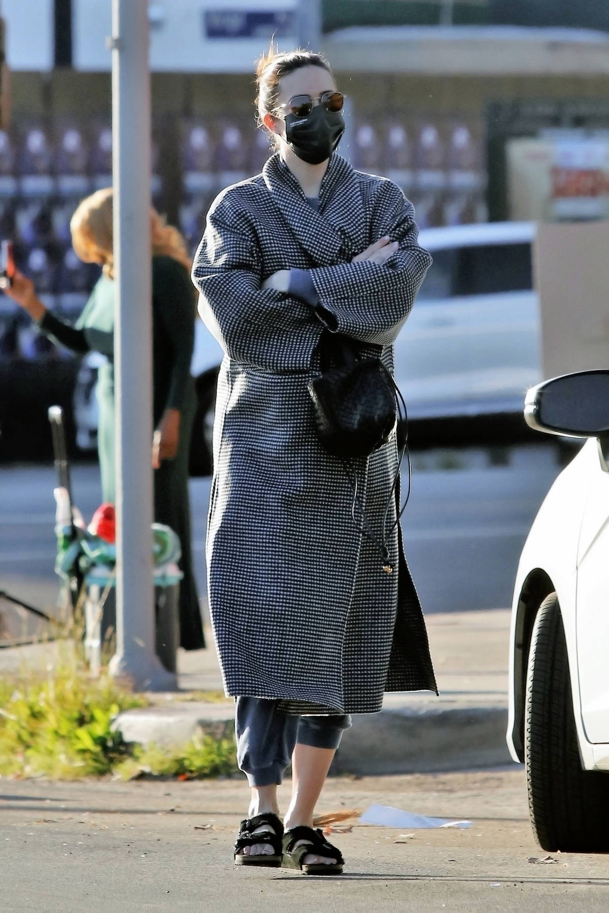 Mandy Moore covers her baby bump while visiting a friend's house in Los Angeles