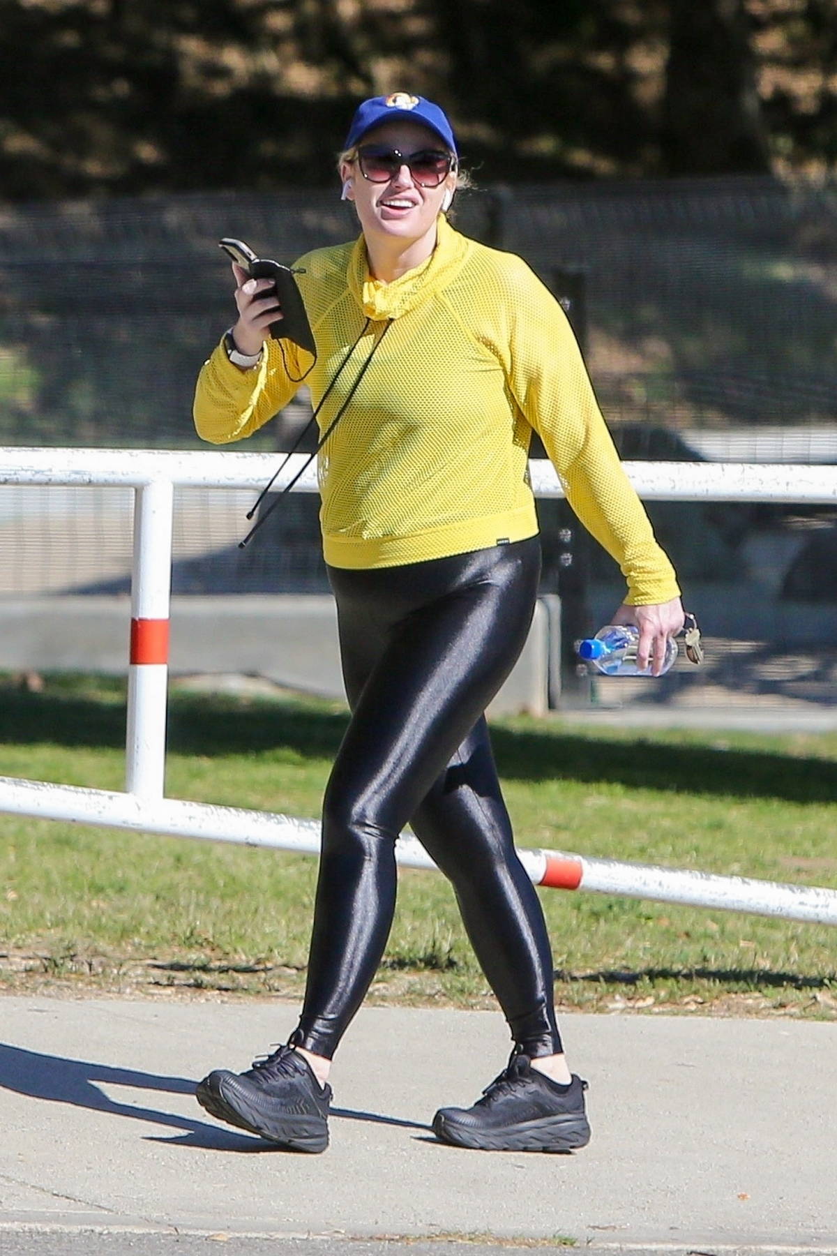 Rebel Wilson stands out in bright yellow hoodie and black leggings