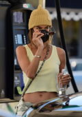 Alessandra Ambrosio flashes her flat abs in a cropped tank top while making a stop at a gas station in Los Angeles