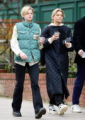 Emma corrin sports 'The North Face x Gucci' designer biker jacket while out for stroll with friends in North London, UK