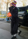 Gigi Hadid keeps it low key as she steps out in a trench coat, shades and a beanie during Milan Fashion Week in Milan, Italy