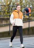 Olivia Wilde looks sporty in a quilted jacket and black leggings as she goes for a morning walk in London, UK