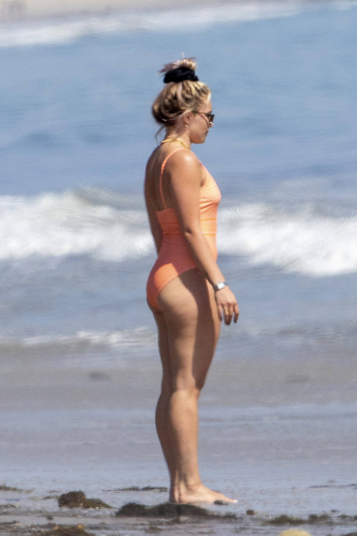 florence pugh seen wearing an orange swimsuit while enjoying a beach day wi...