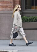 Jennifer Lawrence shows her growing baby bump in a grey sweater and Christian Dior handbag while out in New York City