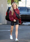 Lindsay Arnold wears a maroon hoodie and camo shorts as she arrives at DWTS studio in Los Angeles