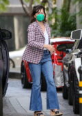 Milla Jovovich wears a plaid jacket and flared jeans for lunch at Beverly Wilshire Hotel in Beverly Hills, California