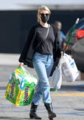 Emma Roberts picks up paper towels and a broom at her local Rite Aid in West Hollywood, California