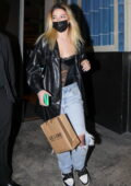 Madelyn Cline wears a black corset top with leather jacket while out for dinner with boyfriend Zack Bia in Los Angeles
