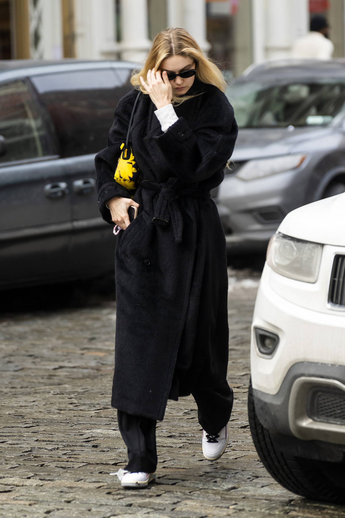 Gigi Hadid bundles up in a black winter coat as she steps out in New York