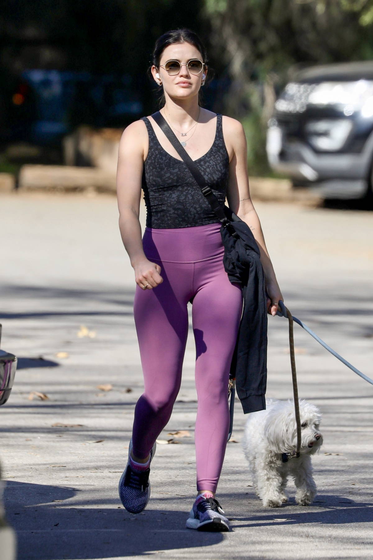 Lucy Hale displays her athletic figure in a black tank top and pink leggings  while out