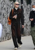 Gigi Hadid shows off her blonde hair with dark overalls while out for a stroll in New York City