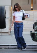 Hailey Bieber flashes her midriff in a crop top and jeans as she leaves after a photoshoot at Milk Studios in Los Angeles