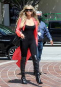 Heidi Klum dons a black bodysuit with knee-high boots and pink trench coat while arriving for AGT taping in Pasadena, California