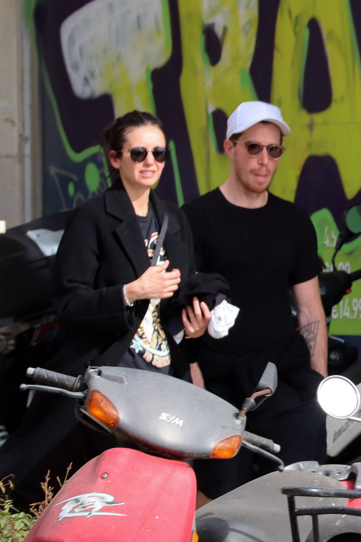 Nina Dobrev and Shaun White hold hands while out on a stroll in