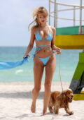 Kimberley Garner scorches the beach in a blue bikini while enjoying a day with her pooch in Miami, Florida