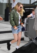 Kristen Stewart wears a green bomber jacket, white tee and denim shorts while leaving her hotel in Cannes, France