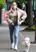 Madelaine Petsch wears a puffer jacket and jeans for a walk in Vancouver, Canada