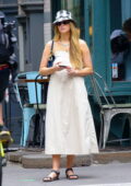 Jennifer Lawrence wears a plaid bucket hat with a white summer dress while out for a stroll in New York City