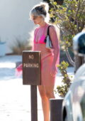 Ashley Roberts shows off her beach body in a pink bikini with a mesh coverup during her vacation in Marbella, Spain