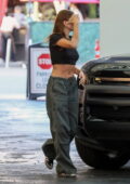 Hailey Bieber shows off her toned midriff in a black crop top while visiting an office building in Beverly Hills, California
