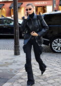 Hailey Bieber rocks a leather coat and flared pants as she steps out during Paris Fashion Week in Paris, France