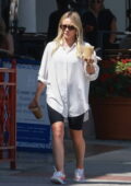 Hilary Duff wears an oversized shirt and legging shorts while she grabs a couple of iced coffees in Sherman Oaks, California