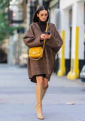 Nina Dobrev looks stylish in a tweed cape and beige knee-high boots while out in Soho, New York City