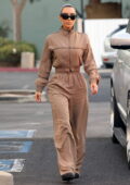 Kim Kardashian puts on a stylish display in a brown jumpsuit as she leaves her daughter North's basketball game in Los Angeles