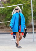 Kim Kardashian stands out in a blue jacket over her skintight romper as she attends her son's soccer game in Los Angeles