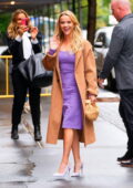 Reese Witherspoon looks great in a tan trench coat over a purple dress while visiting 'The View' in New York City