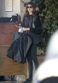 Kaia Gerber carries a large Celine shopping bag as she leaves the Sunset Towers hotel in Beverly Hills, California