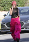Addison Rae looks cute in pink cargo pants with a black crop top and beanie while heading to a Pilates class in Los Angeles