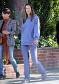 Alessandra Ambrosio looks cozy as she steps out in a matching purple hoodie, flared leggings and slippers in Los Angeles