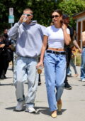 Hailey Bieber flashes her toned midriff while stepping out with hubby Justin Bieber after a Rhode pop-up event in Los Angeles