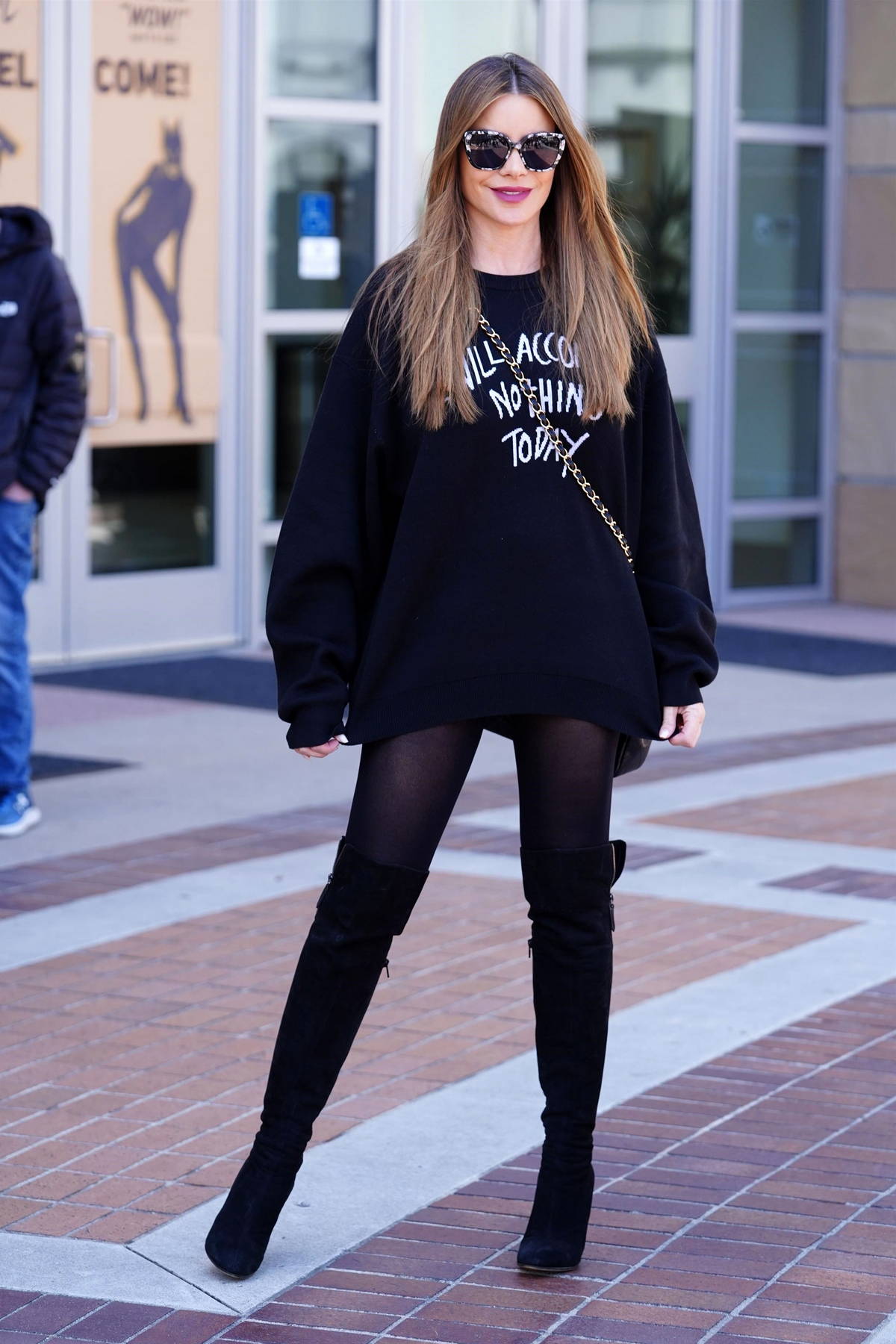 sofia vergara rocks an oversized black sweater with matching tights and  boots as she arrives at agt studios in pasadena, california-060423_8