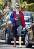 Elizabeth Olsen keeps it casual in red and blue jacket with a grey top and black leggings during a solo outing in Los Angeles