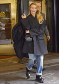 Margot Robbie is all smiles as she leaves her hotel in New York City