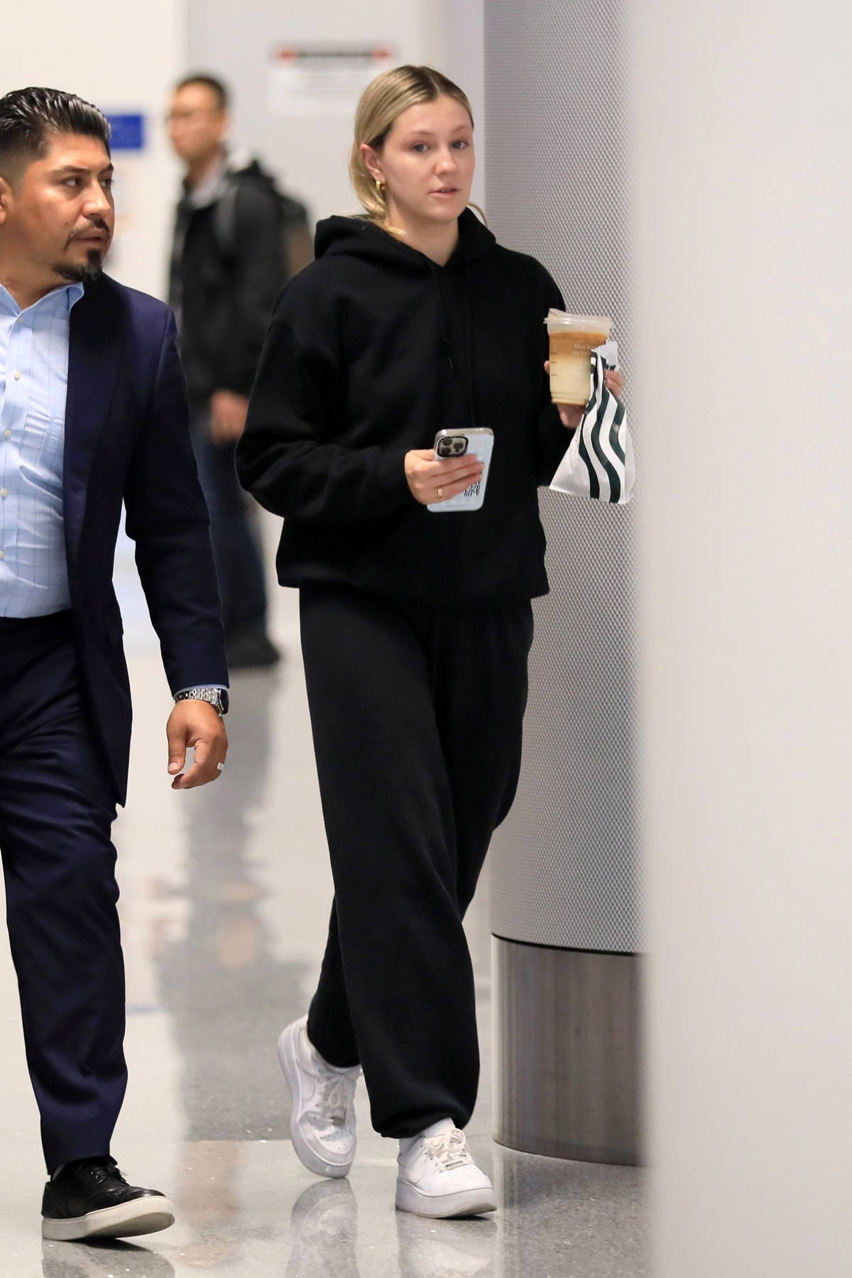 Ava Sambora enjoys her iced coffee as she arrives at LAX in Los Angeles