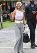 Ashley Roberts flashes her abs in a cropped white tank top while leaving Heart Radio in London, UK