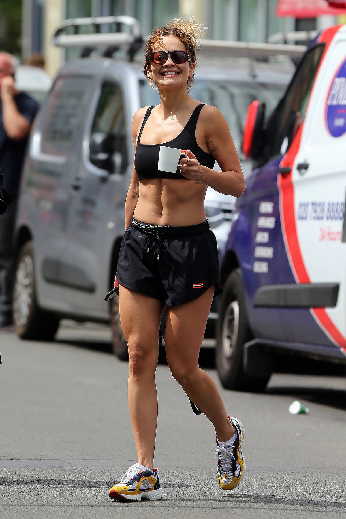 Rita Ora showcases her amazing abs in a black sports bra and