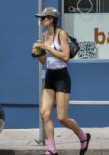 Amelia Hamlin displays her toned body in a white tank top and navy spandex shorts while grabbing a matcha drink in Los Angeles