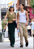 Kaia Gerber wears an olive green vest paired with green trousers while out for a stroll with BFF Travis Jackson in New York City