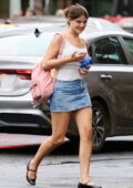 Suri Cruise is all smiles while stepping out in a white top and denim skirt in New York City