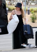 Margot Robbie keeps a low profile in a Chanel bucket hat as she arrives at the airport with husband Tom Ackerley in Brisbane, Australia