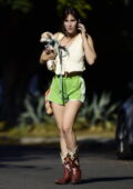 Scout Willis flaunts her legs in bright green shorts and cowgirl boots while stepping out with her pup in Los Angeles