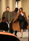 Miranda Kerr shows of her growing baby bump in a black dress during a date night with husband Evan Spiegel in Los Angeles