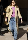Emma Watson is all smiles as she heads out wearing a khaki trench coat in Milan, Italy