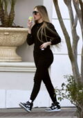 Khloe Kardashian enjoys an ice cream while stepping out in all-black attire in Calabasas, California