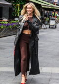 Perrie Edwards flashes her toned abs in brown crop top and leggings while seen outside Global Radio studios in London, England
